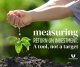 outstretched hands pour water into growing seedling