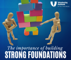 Two articulated artists mannequins look at a stack of coloured blocks teetering on a too-small foundation