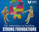 Two articulated artists mannequins look at a stack of coloured blocks teetering on a too-small foundation