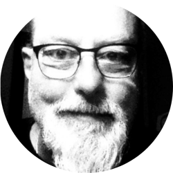 Head shot of a man with glasses and a beard