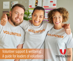 two women and one man smiling with thumbs up wearing t shirts with volunteer printed on the front