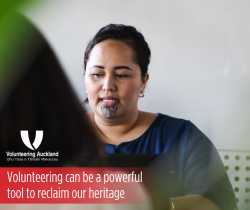 a maori woman with a chin tattoo reading te reao language book