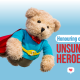 Teddy bear flying in a red cape and blue t-shirt. caption Honouring our Unsung Heroes