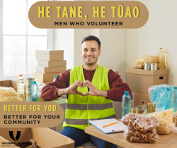 A man smiling among boxes of donations