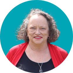 Head shot of a smiling woman with mid brown hair